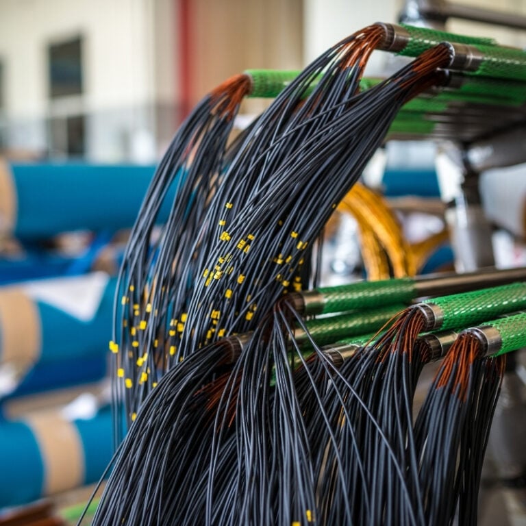 Fiber optic cables spilling out of cable guards.